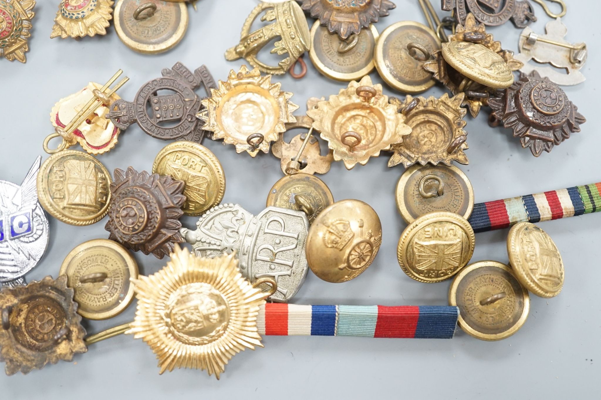 A quantity of cap badges, buttons and badges